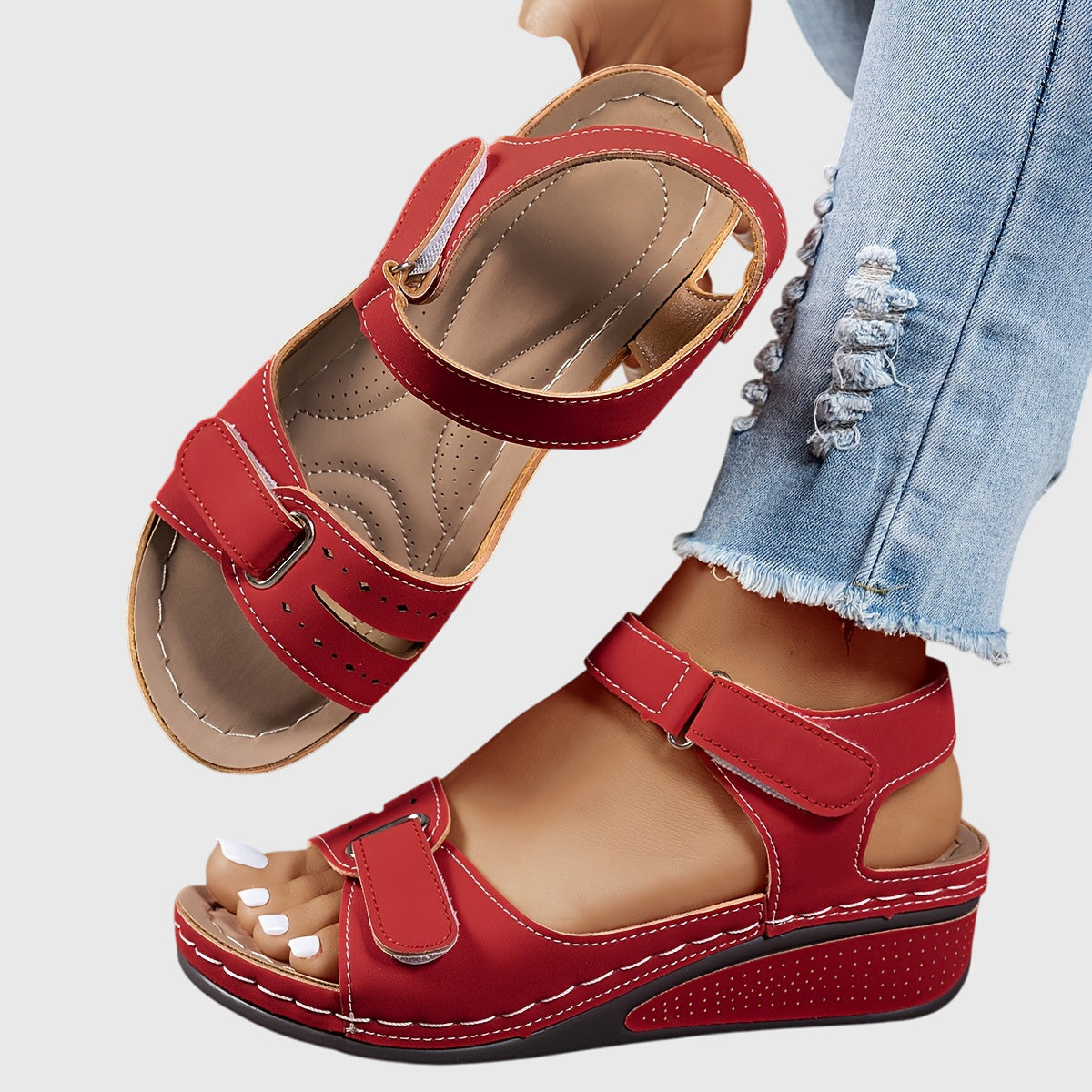 Women's orthopedic sandals in red with adjustable ankle strap and contoured footbed, worn with distressed denim