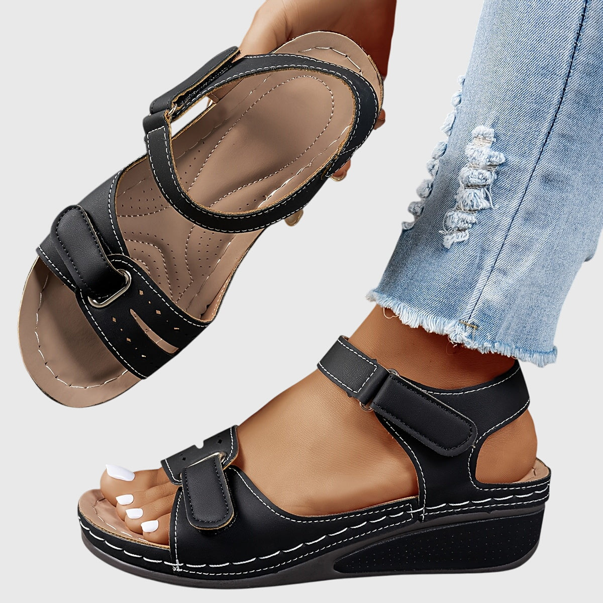 Side view of women's orthopedic sandals displaying low wedge sole with contrast stitching