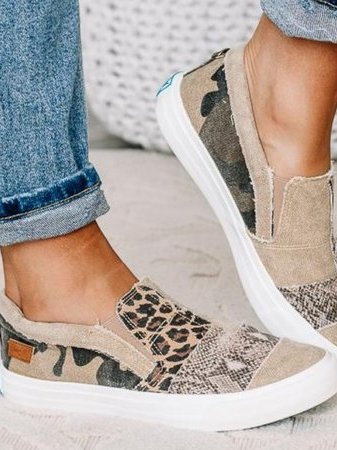 Women's canvas loafers with mixed-print design featuring beige, leopard, and snakeskin textures on casual sneaker silhouette