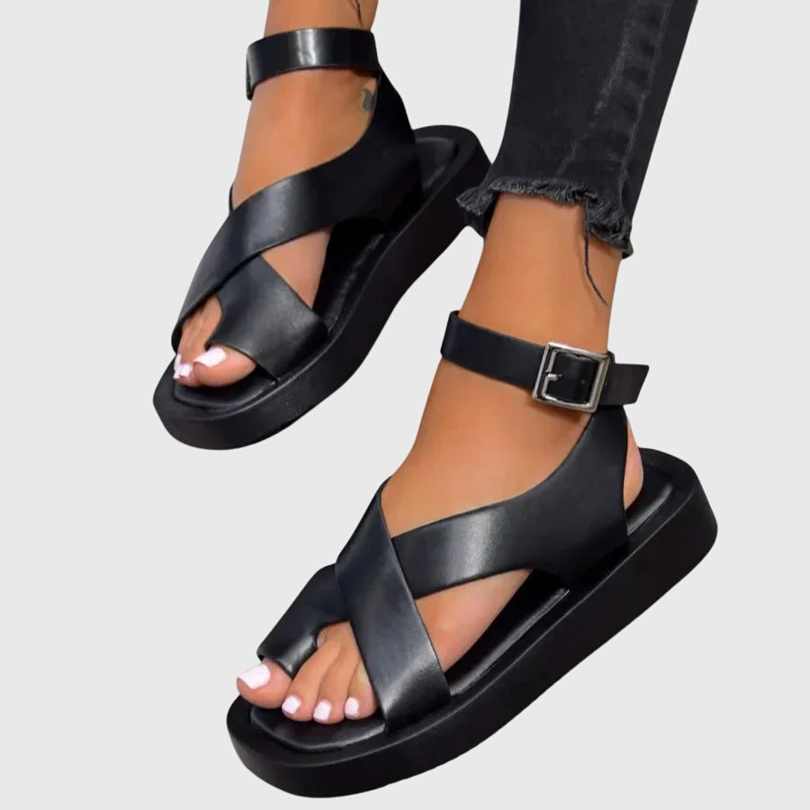 Side view of strappy gladiator platform sandals showing multiple crisscross straps and chunky black platform sole with coral orange upper