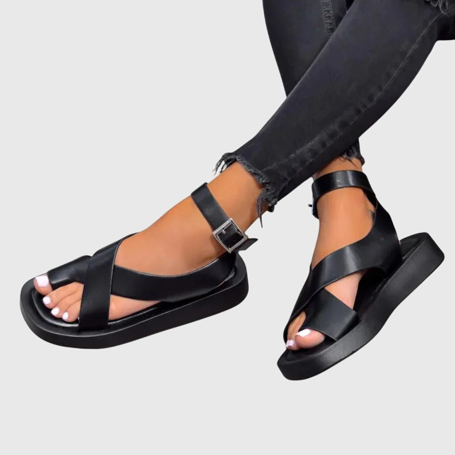 Platform sole side profile showing height and stability of women's strappy gladiator sandals with black base and coral straps