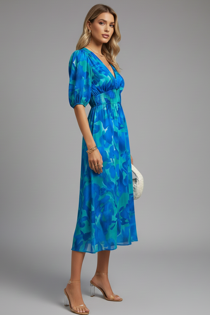 Full-length view of blue floral print midi dress with relaxed silhouette and feminine puff sleeve design