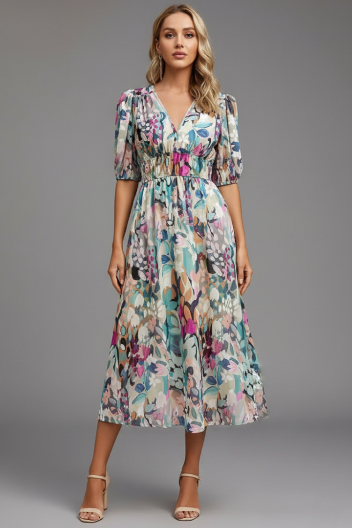 Close-up of V-neckline and puff sleeve detail on women's floral midi dress with gathered bodice