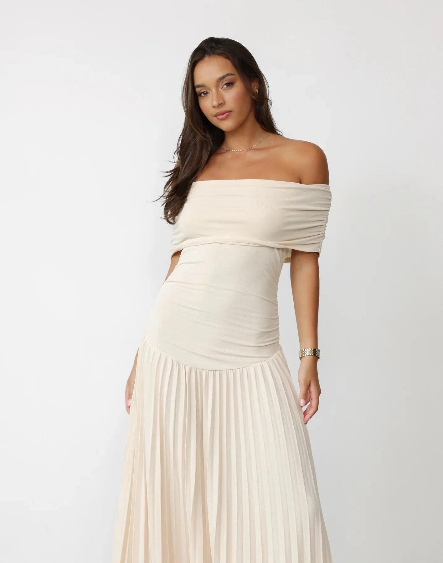 Full silhouette of flowing maxi dress with defined waist and pleats