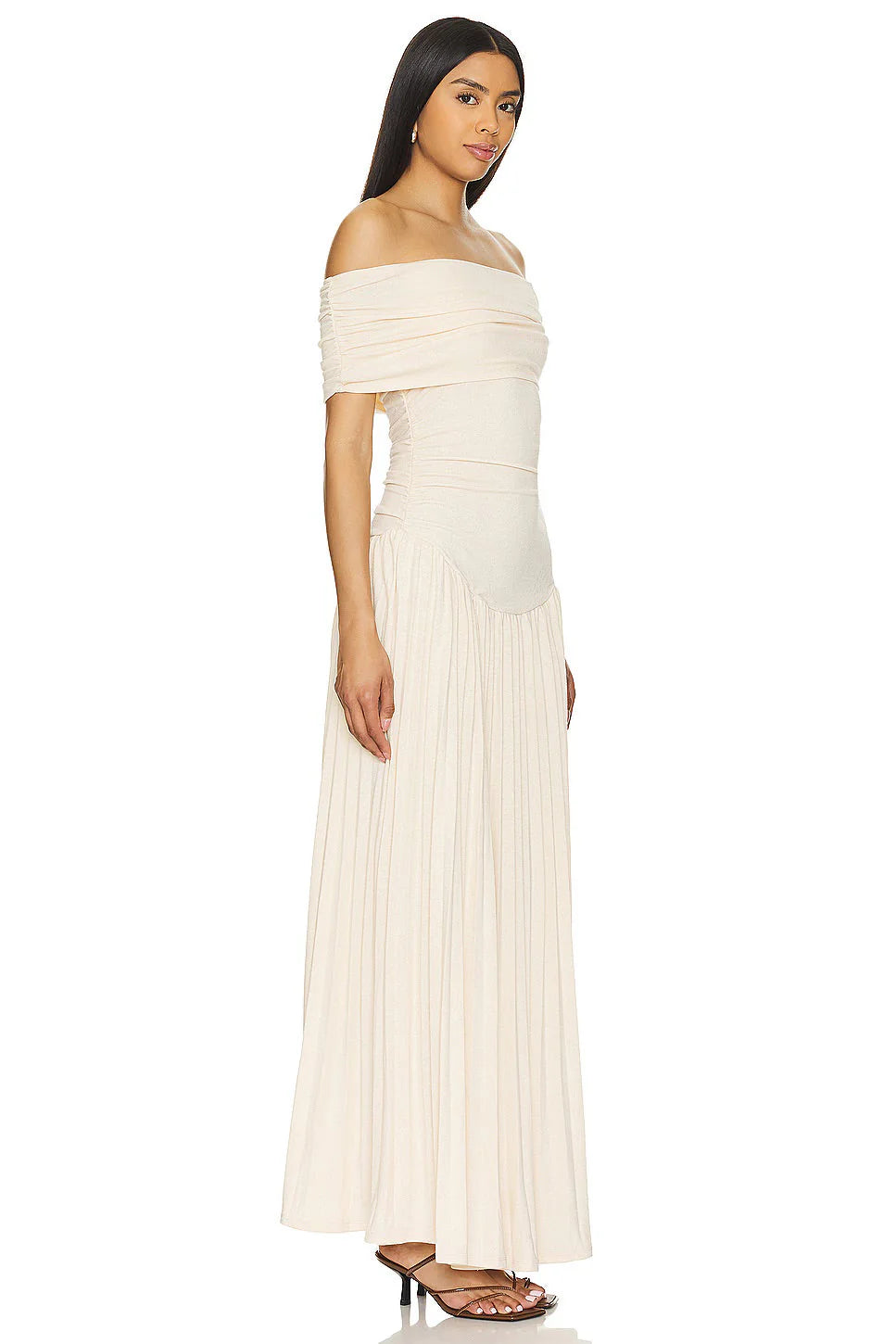 Model in off shoulder maxi dress with pleated skirt and fitted waist