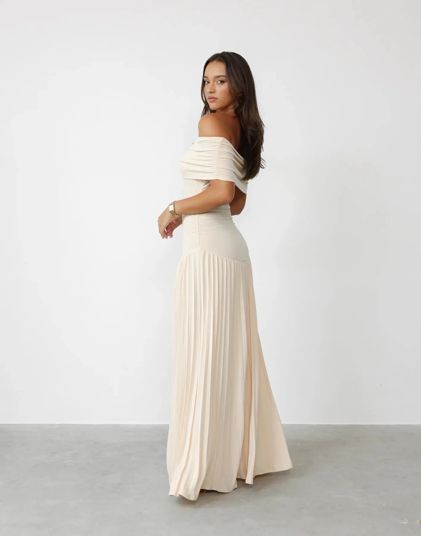 Front view of off shoulder maxi dress showing ruched bodice and flowing skirt