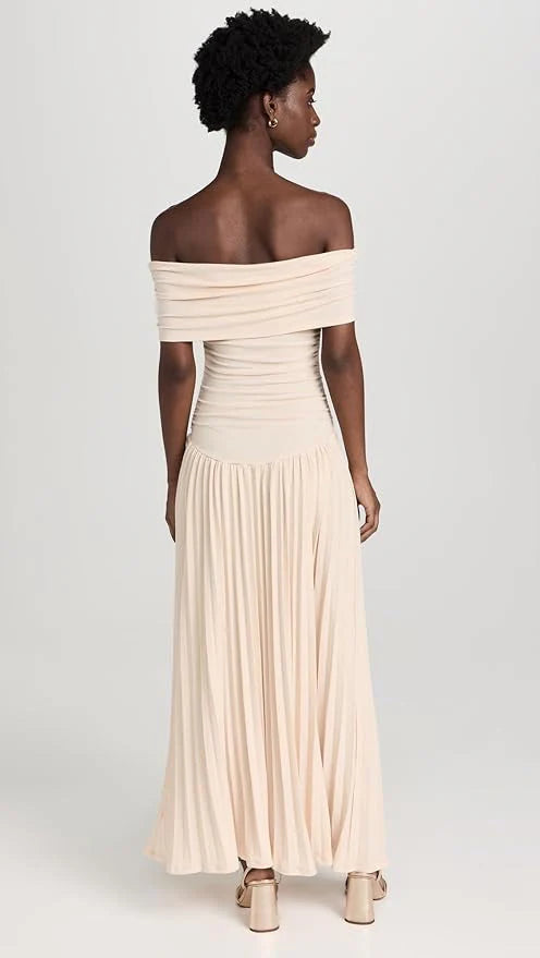 Back view of maxi dress showing off shoulder design and pleated hem