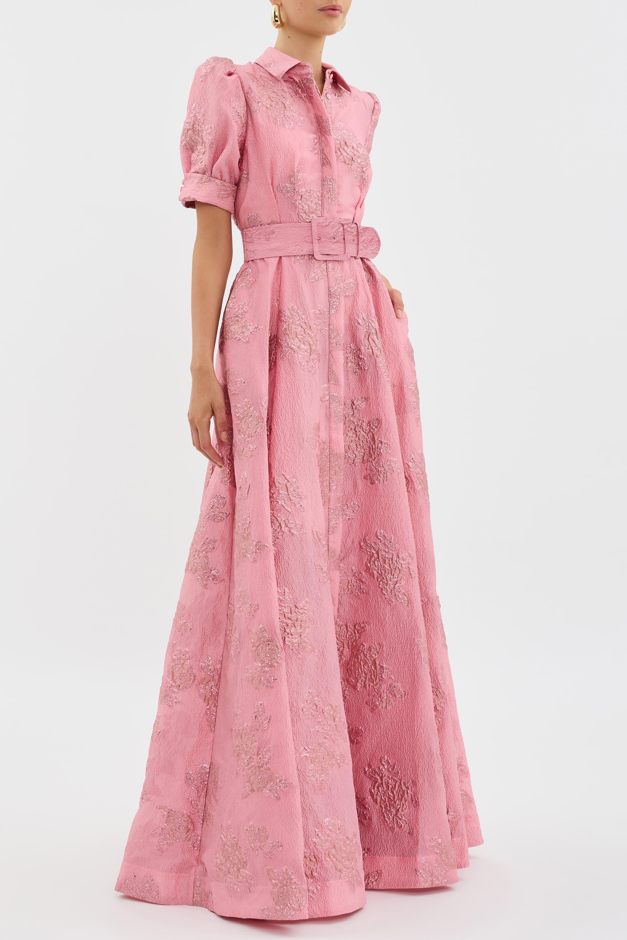 Formal pink maxi dress featuring collared neckline and button-front closure with matching belt