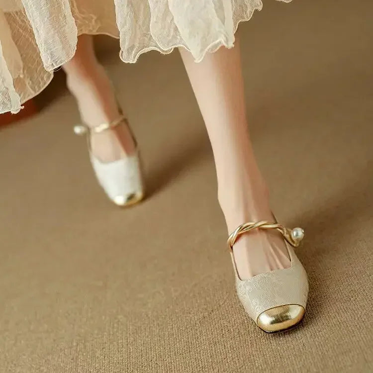 Side angle of Women's Pearl Strap Mary Jane Shoes with glitter block heel on neutral background