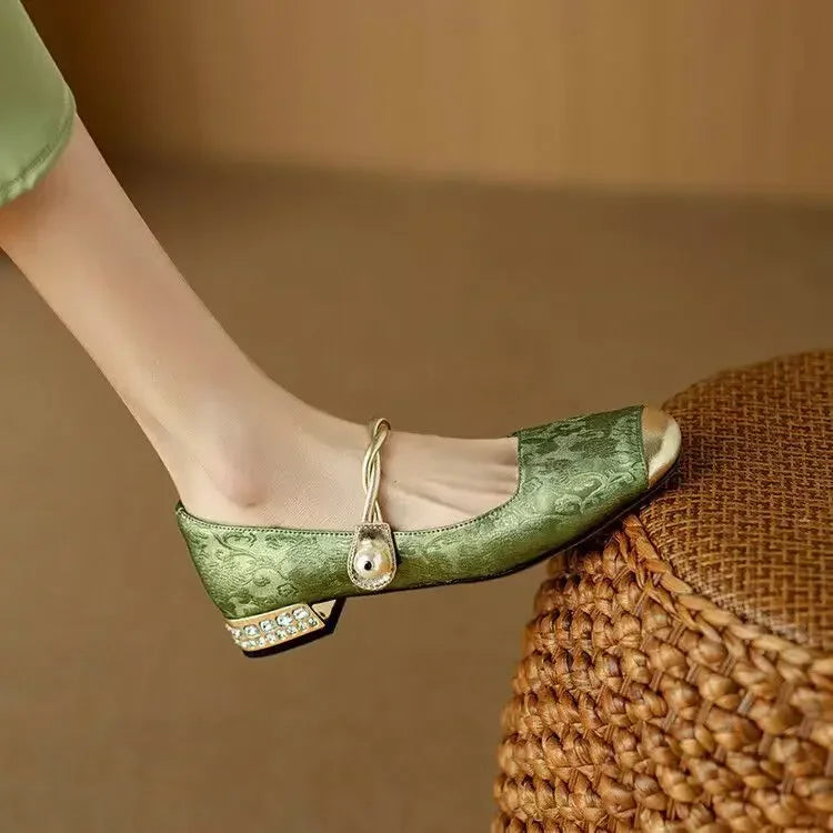 Model wearing sage green Mary Jane shoes with glitter block heel paired with midi dress