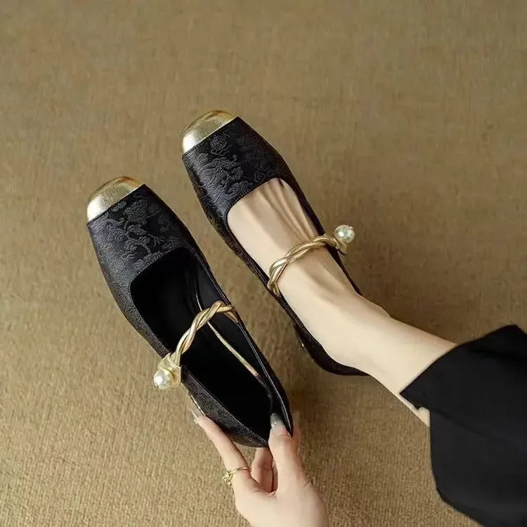 Detail shot of adjustable pearl-accented ankle strap on Mary Jane shoes with metallic hardware