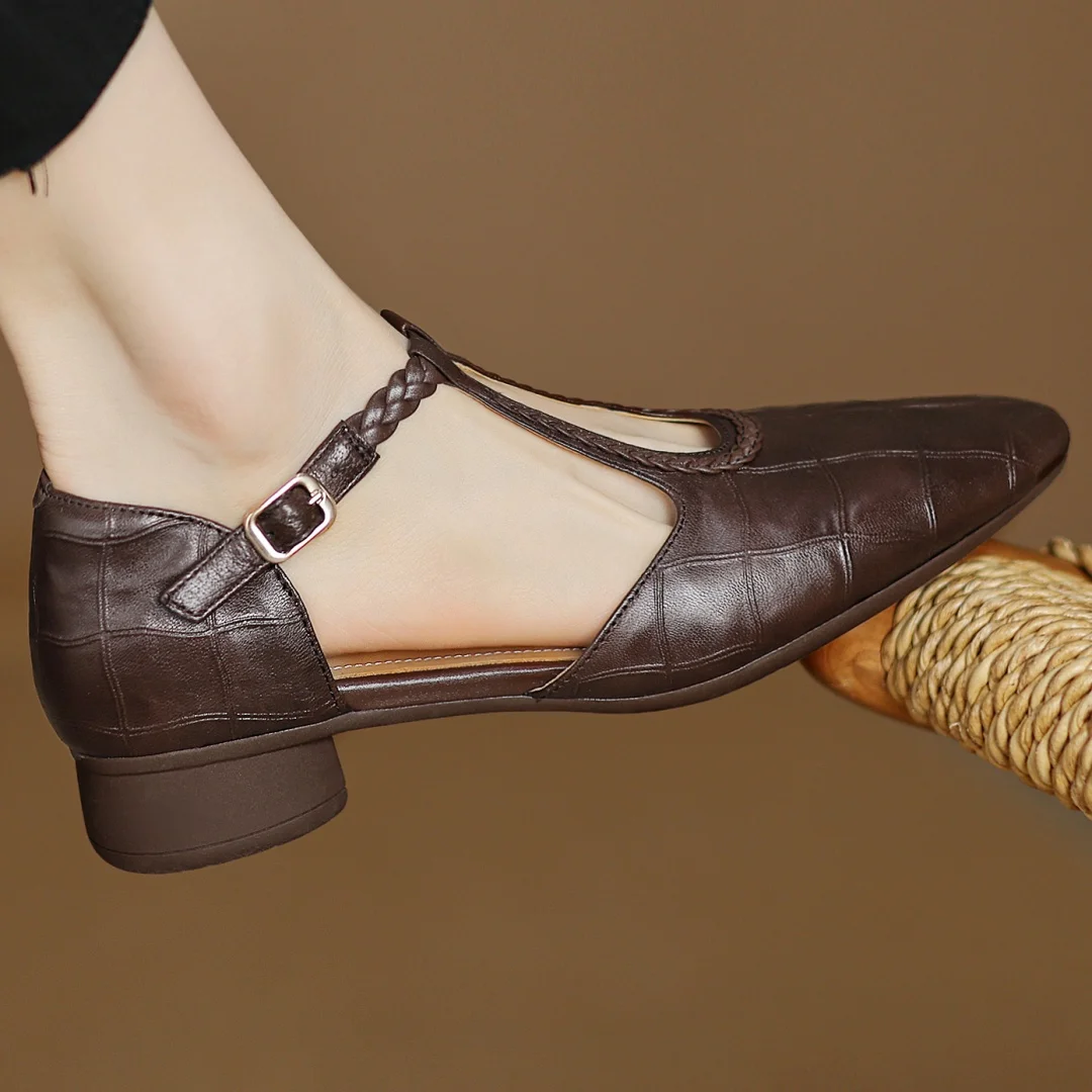 Side angle of women's leather T-strap mary jane flats showing flat cushioned sole and structured upper