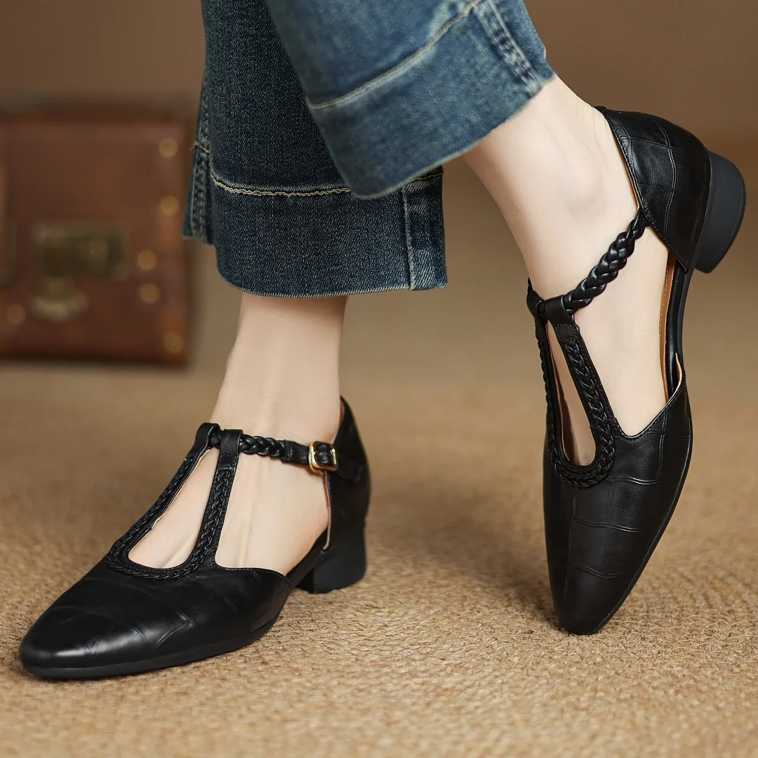 Detail shot of adjustable metal buckle and braided leather strap on mary jane flats