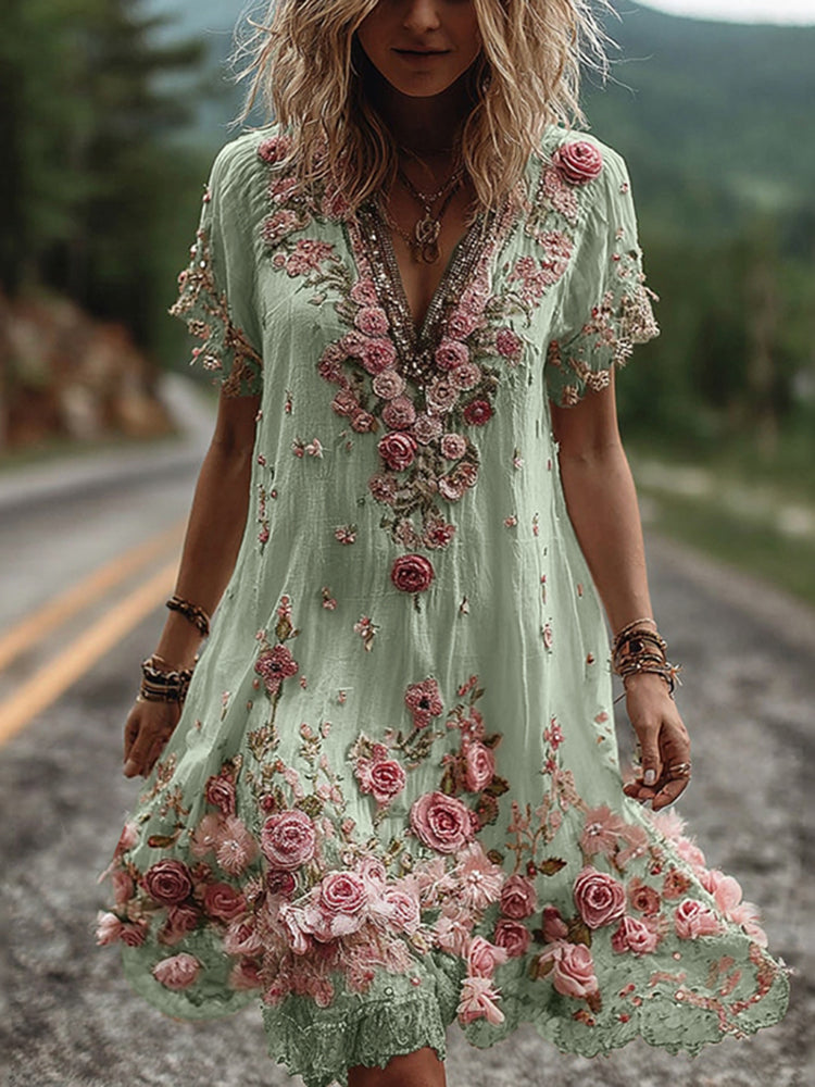 Back view of embroidered dress showing continued floral appliqué design and flowing A-line cut