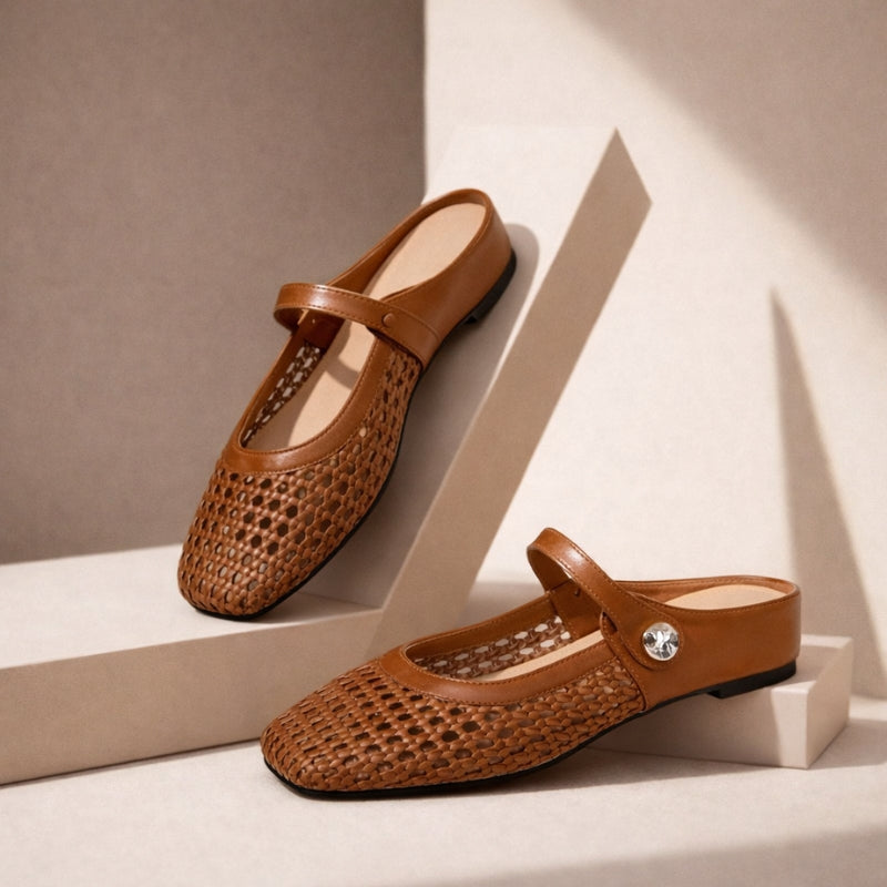 Women's woven flat slip-on shoes with Mary Jane strap positioned on neutral background with shadow