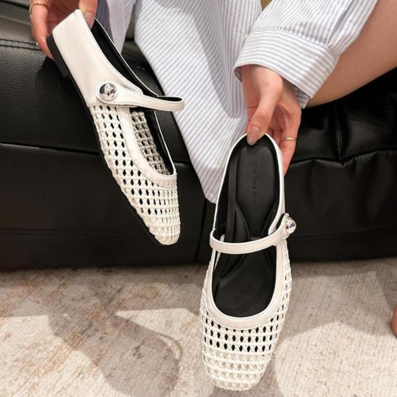 Pair of women's slip-on mules with square toe and open-weave metallic upper in natural lighting