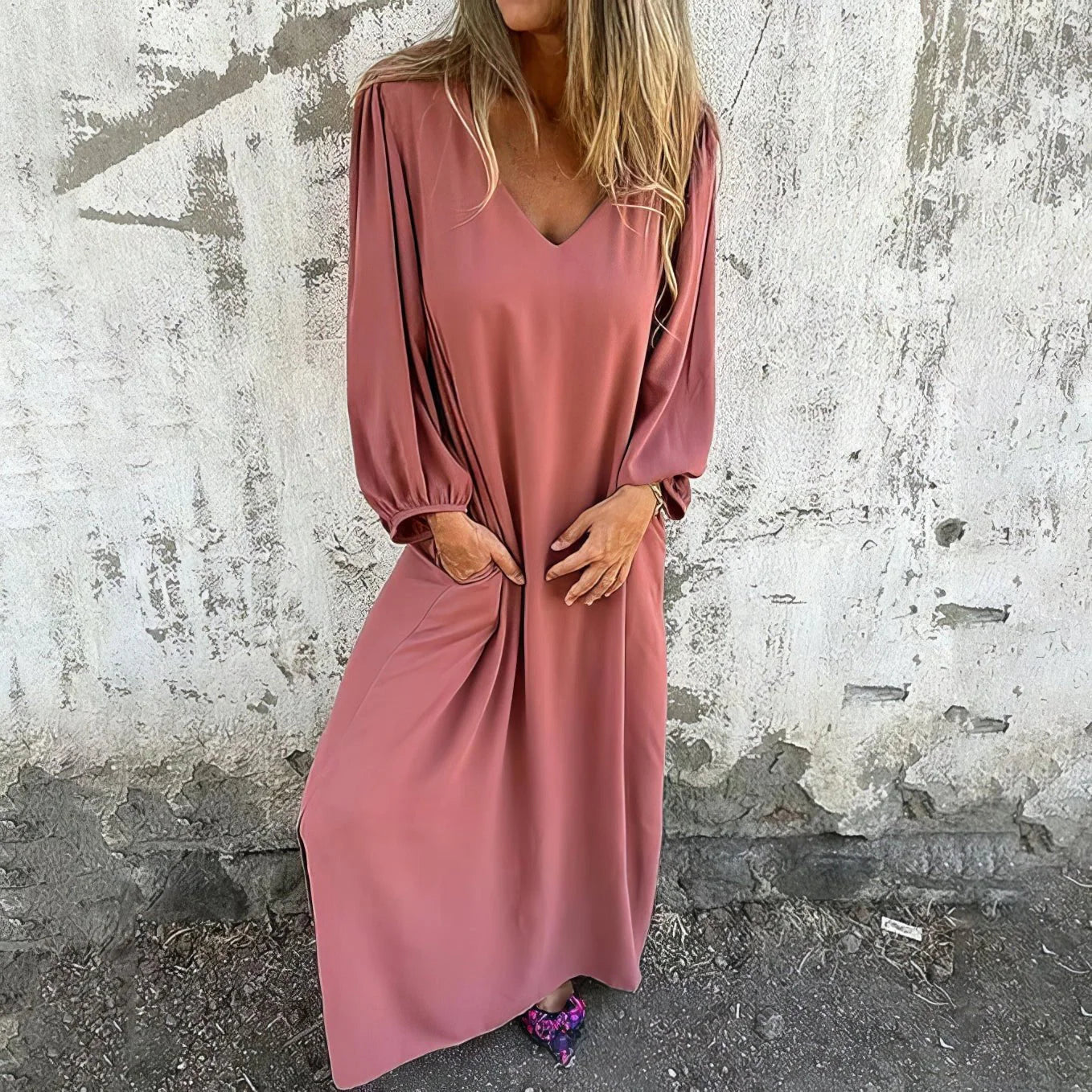 Close-up view of the V-neckline and gathered bishop sleeve detail on the red maxi dress