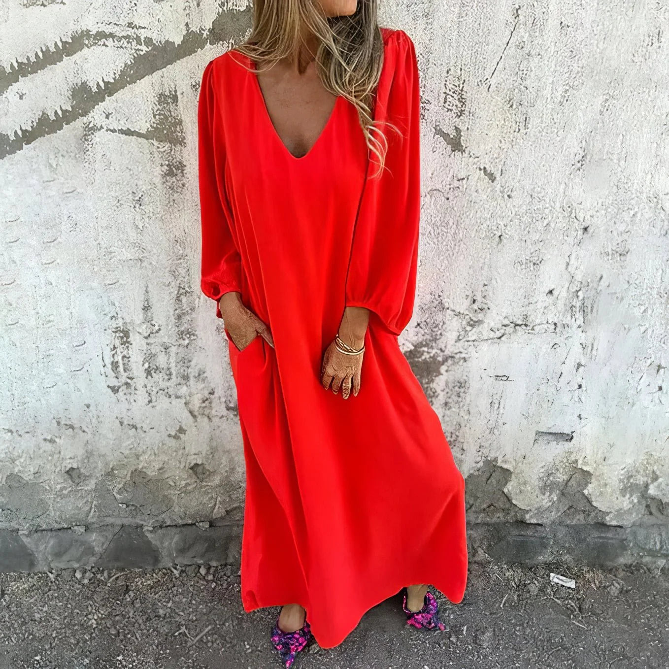 Detail shot of the bishop sleeve cuffs and flowing fabric drape on the maxi dress