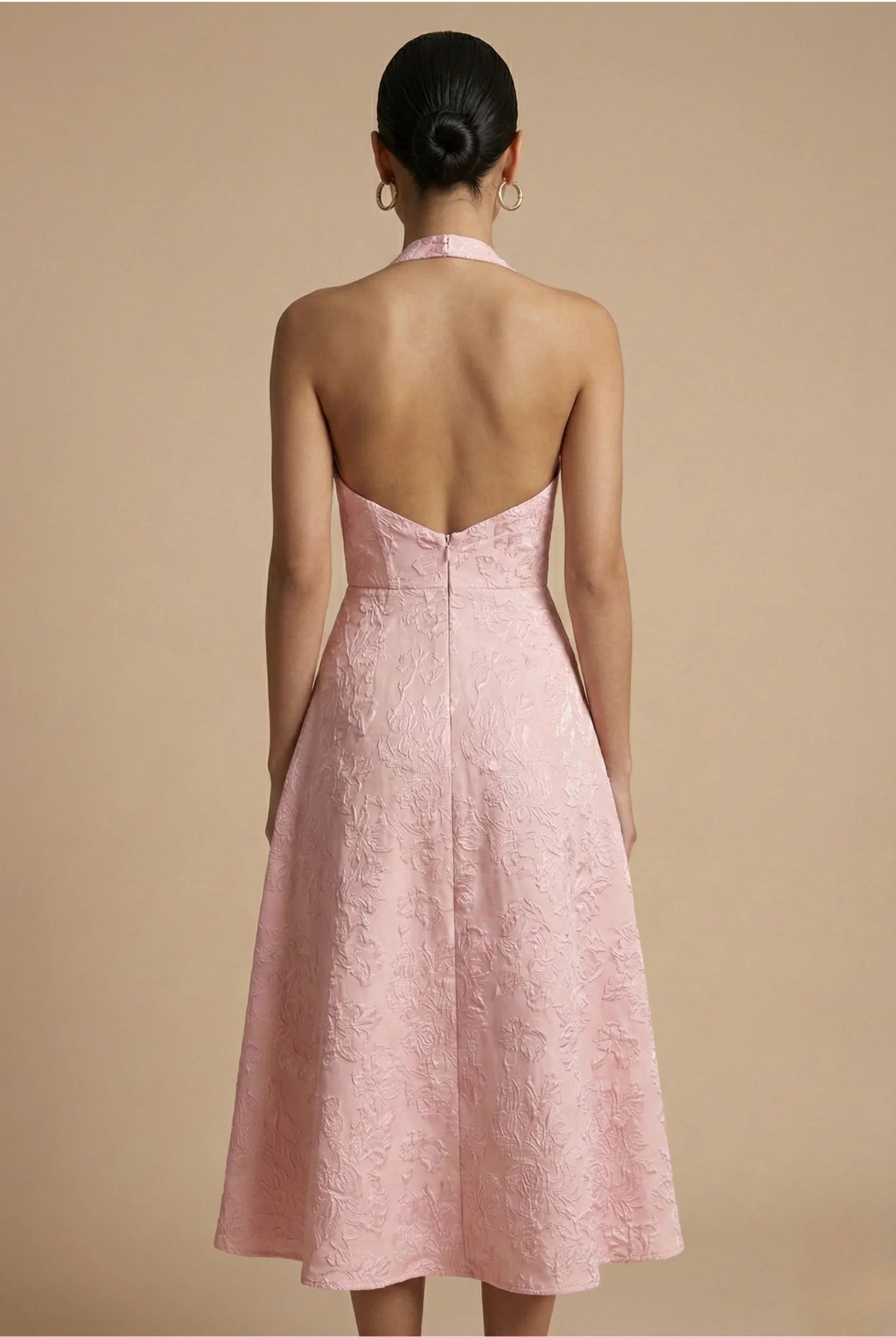 Side angle of halter midi dress displaying open back and tie closure detail