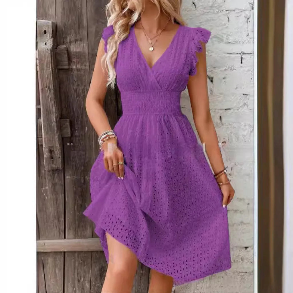 Woman wearing eyelet summer dress outdoors showing relaxed A-line fit and feminine details