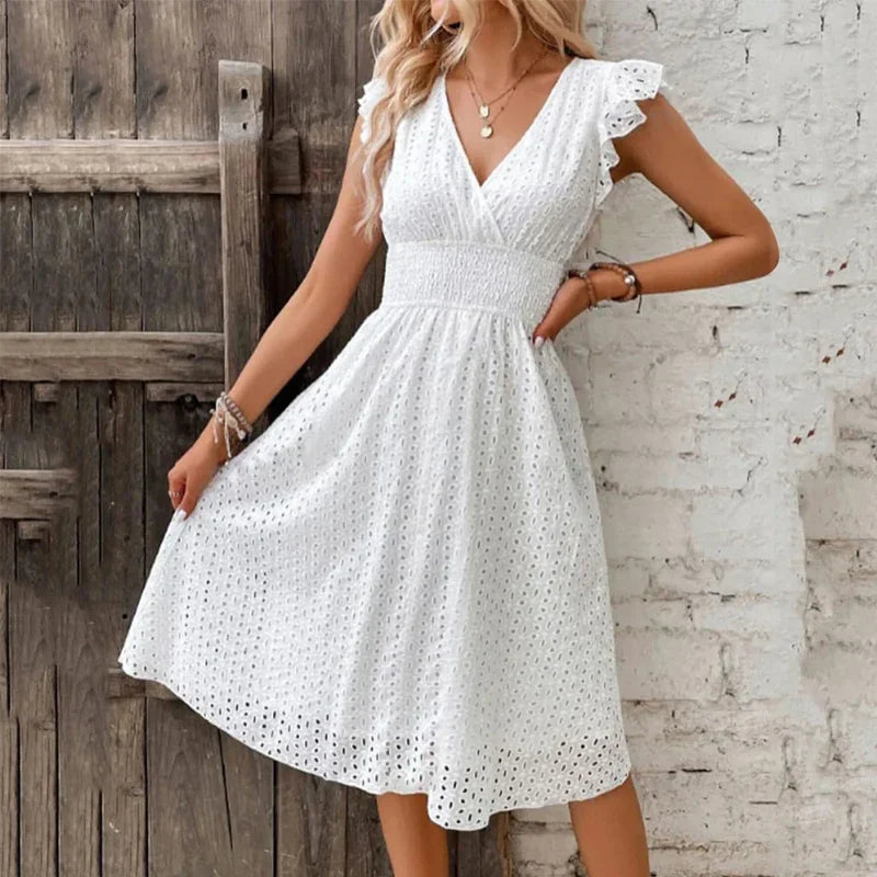Close-up view of V-neck summer dress showing eyelet cutout pattern and ruffled cap sleeves