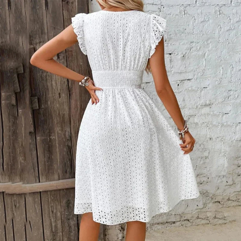 Side angle of knee-length summer dress featuring A-line silhouette and elastic smocked waistband