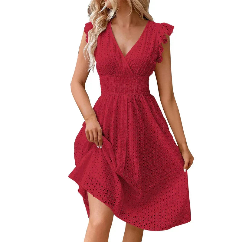 Woman modeling V-neck dress showing smocked waist definition and knee-length hemline