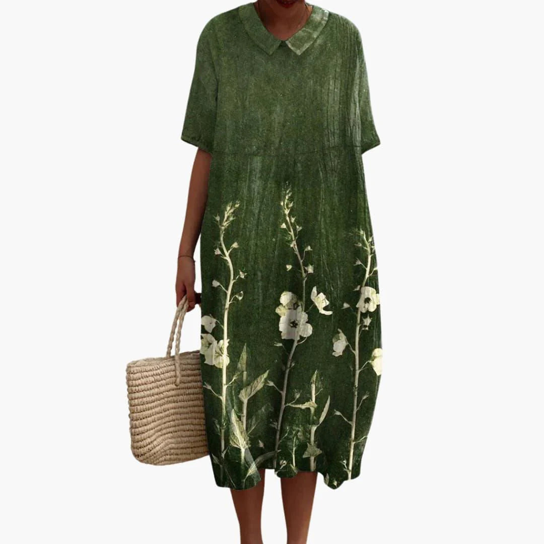 Close-up view of crinkle-textured floral midi dress showing colorful bloom pattern and V neck detail