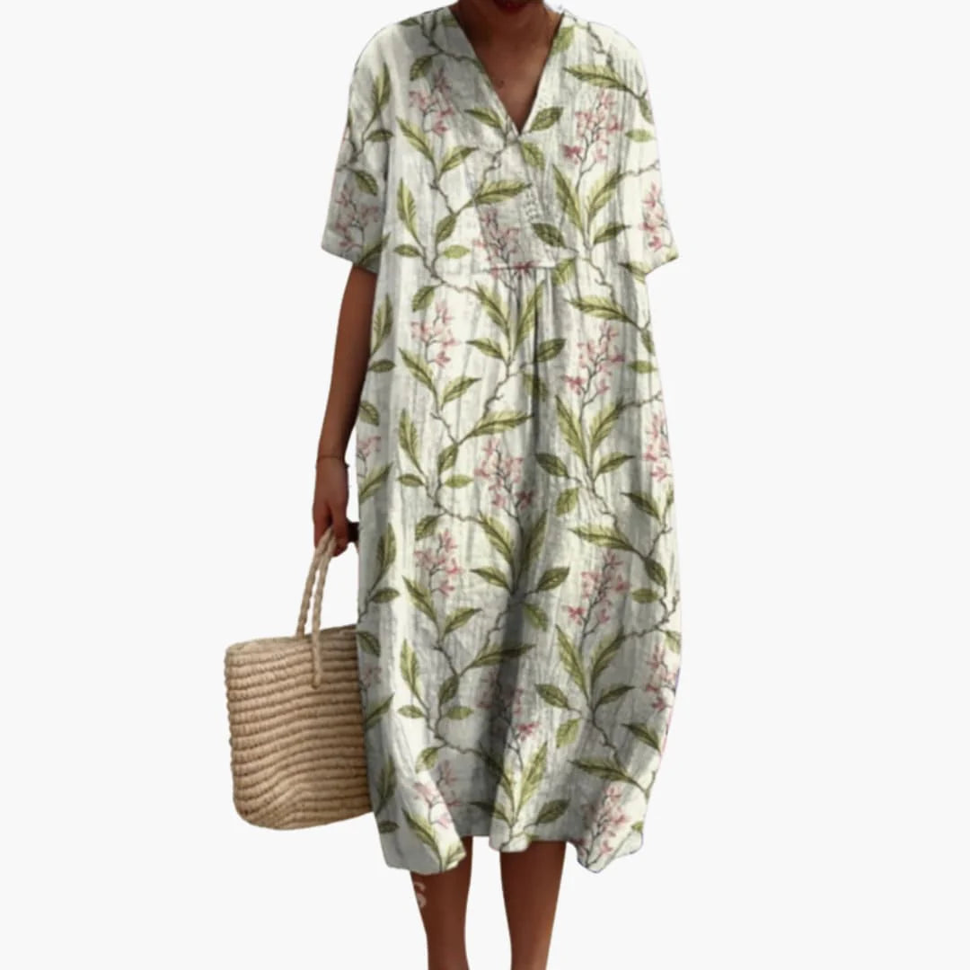 Model wearing oversized floral midi dress styled with flat sandals for casual summer look