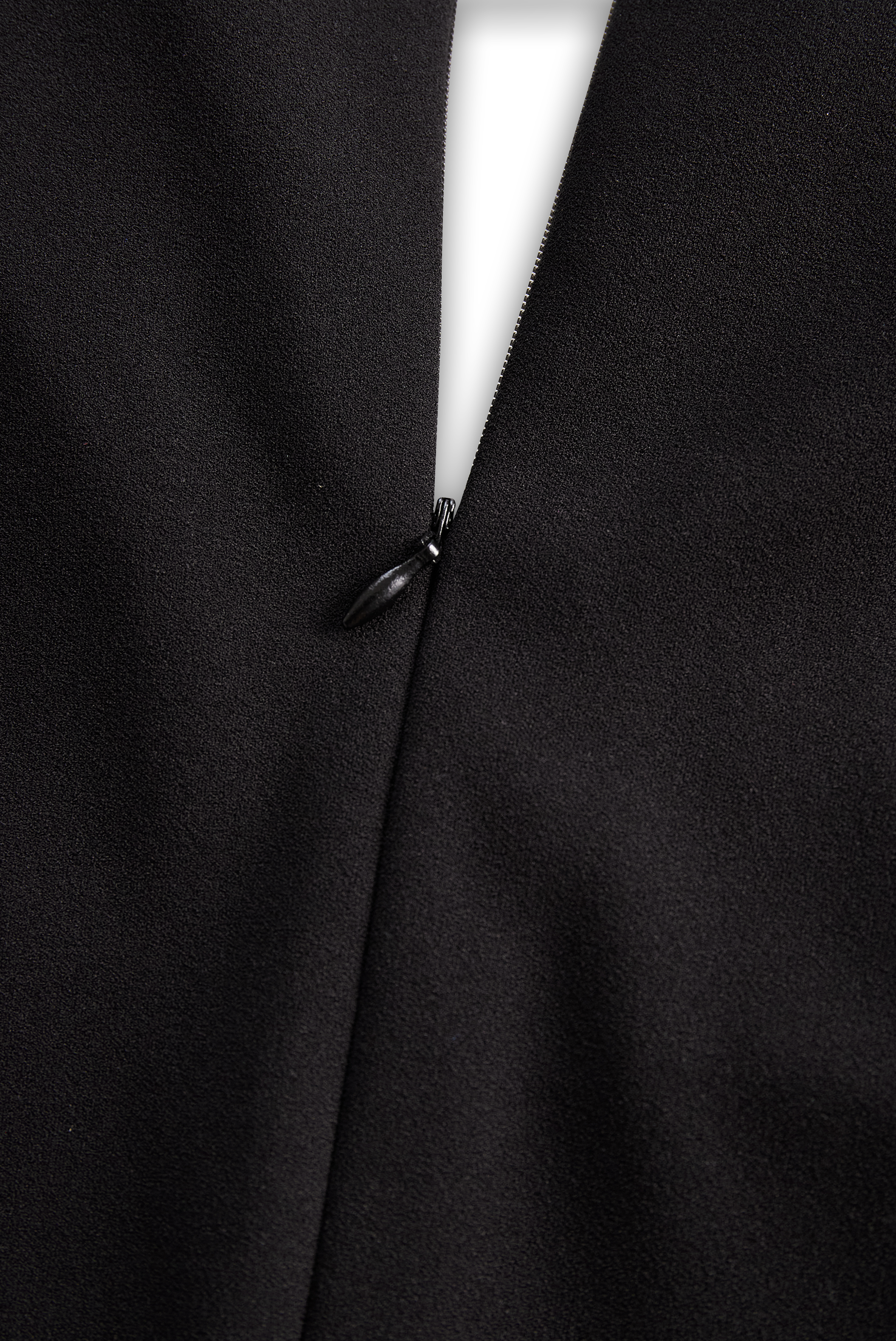 Close-up of refined midi dress shoulder structure and sleeve design
