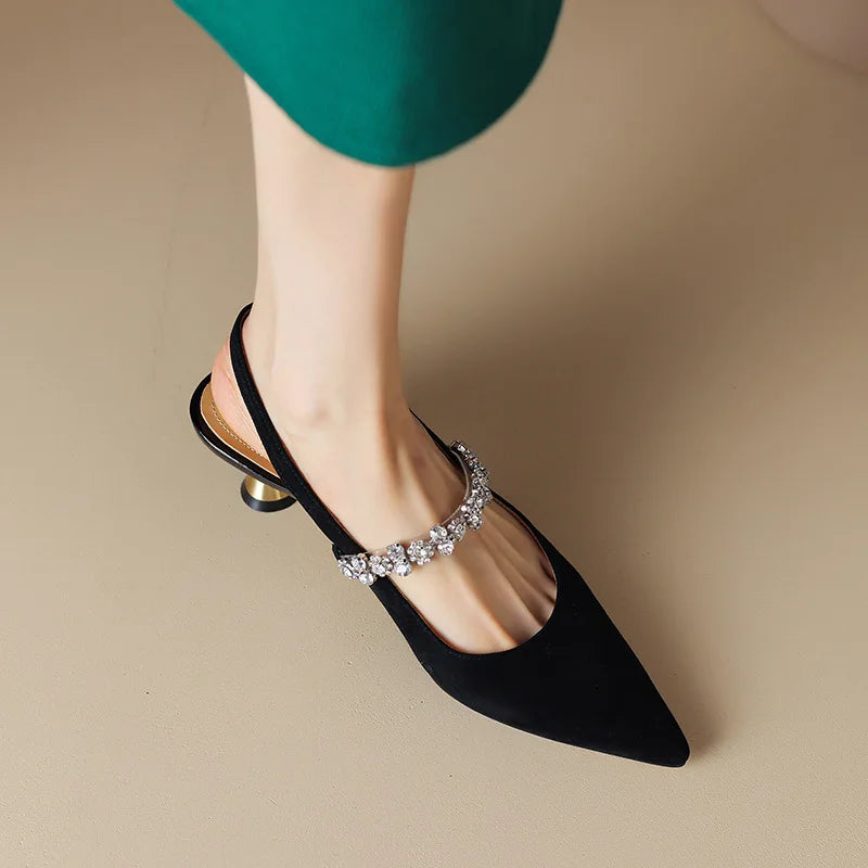 Full view of women's crystal strap slingback heels in silver showing pointed toe and metallic construction