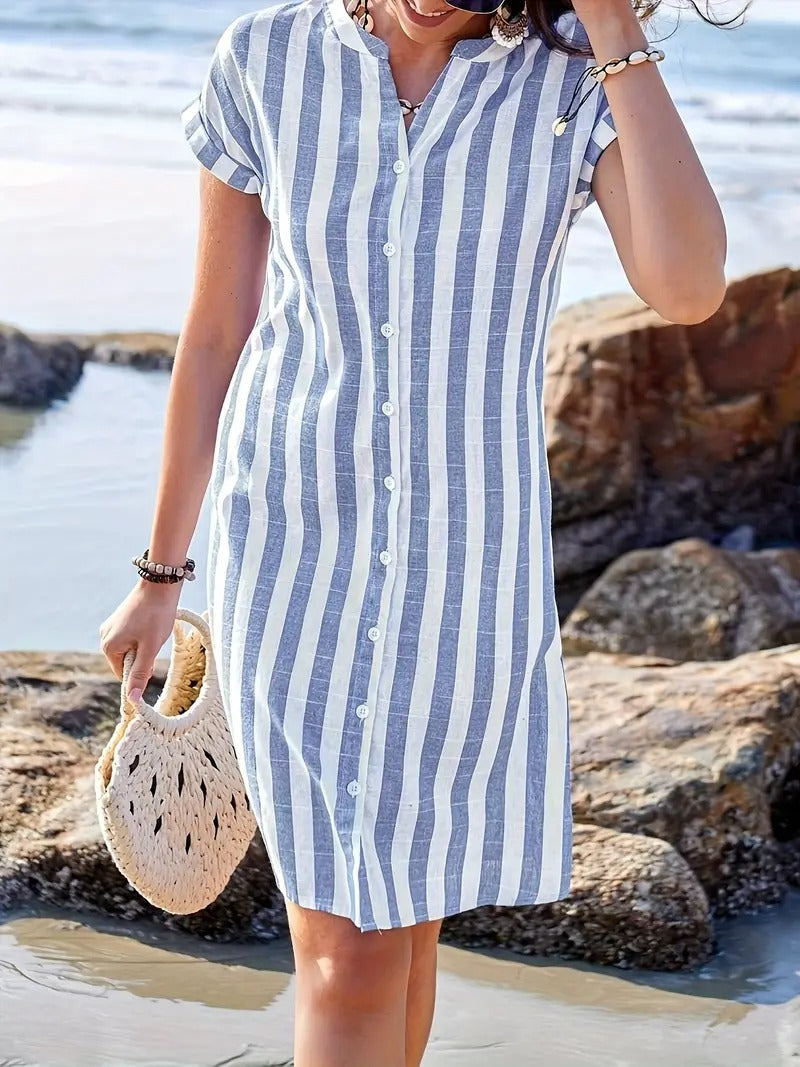 Close-up of linen striped shirt dress showing button-front closure and V-neckline detail