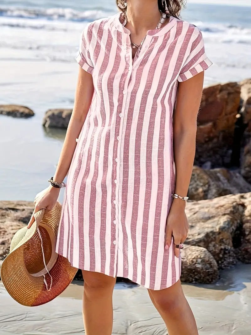 Side view of relaxed fit linen striped shirt dress with short sleeves and knee-length hem