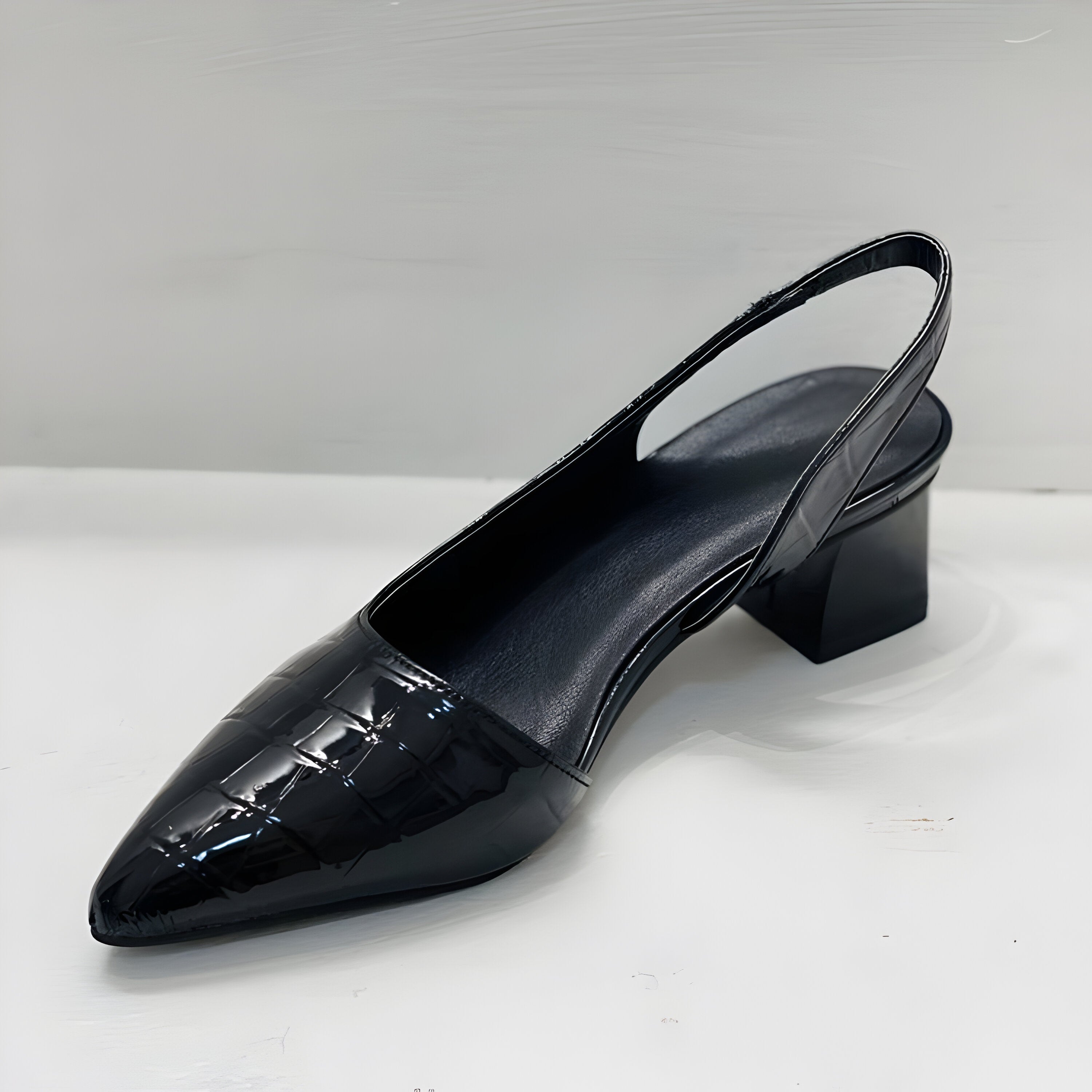 Detail of slingback strap and pointed toe front on supportive low heel shoes