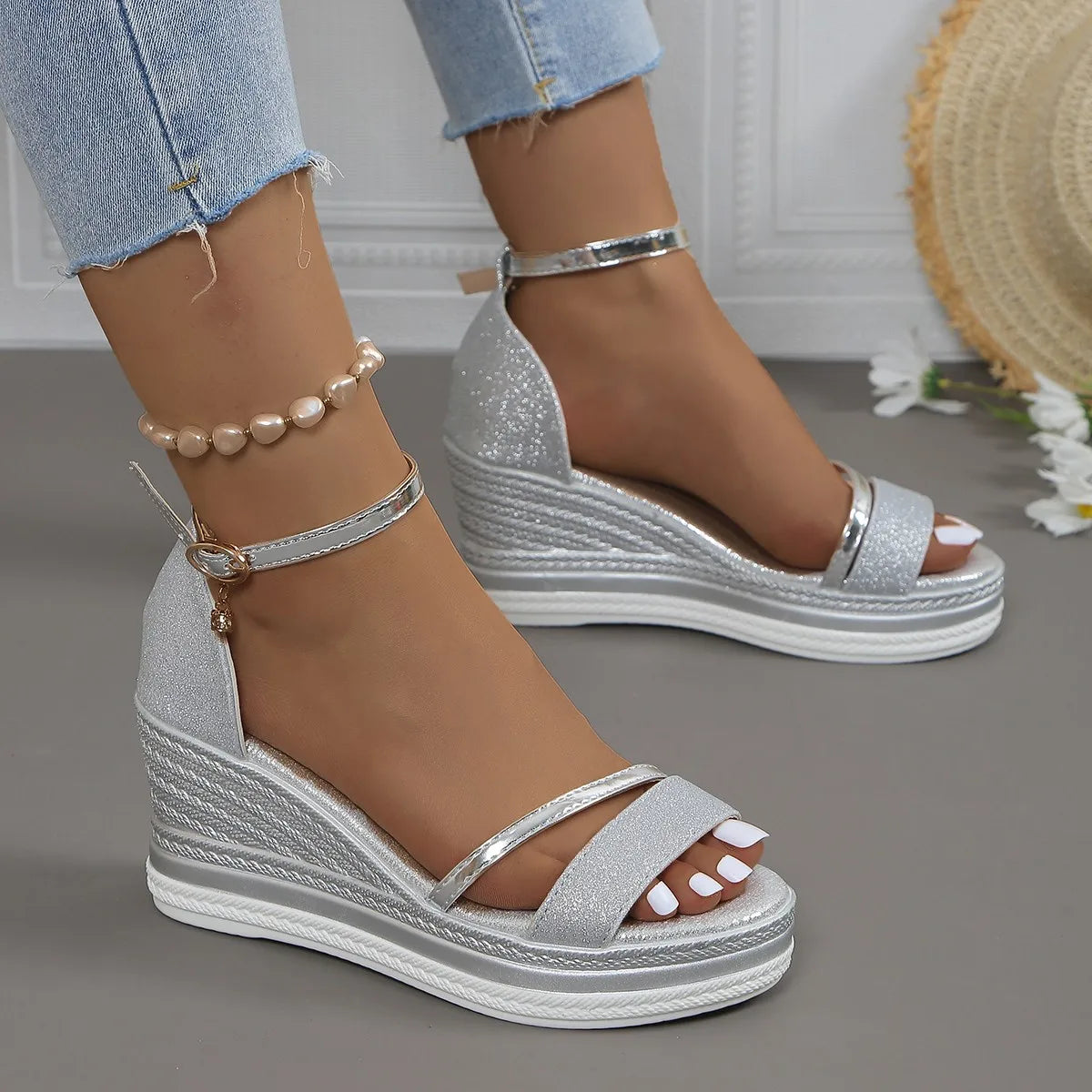 Close-up of womens platform wedge strap sandals showing glitter-embellished front strap and rope-textured wedge sole
