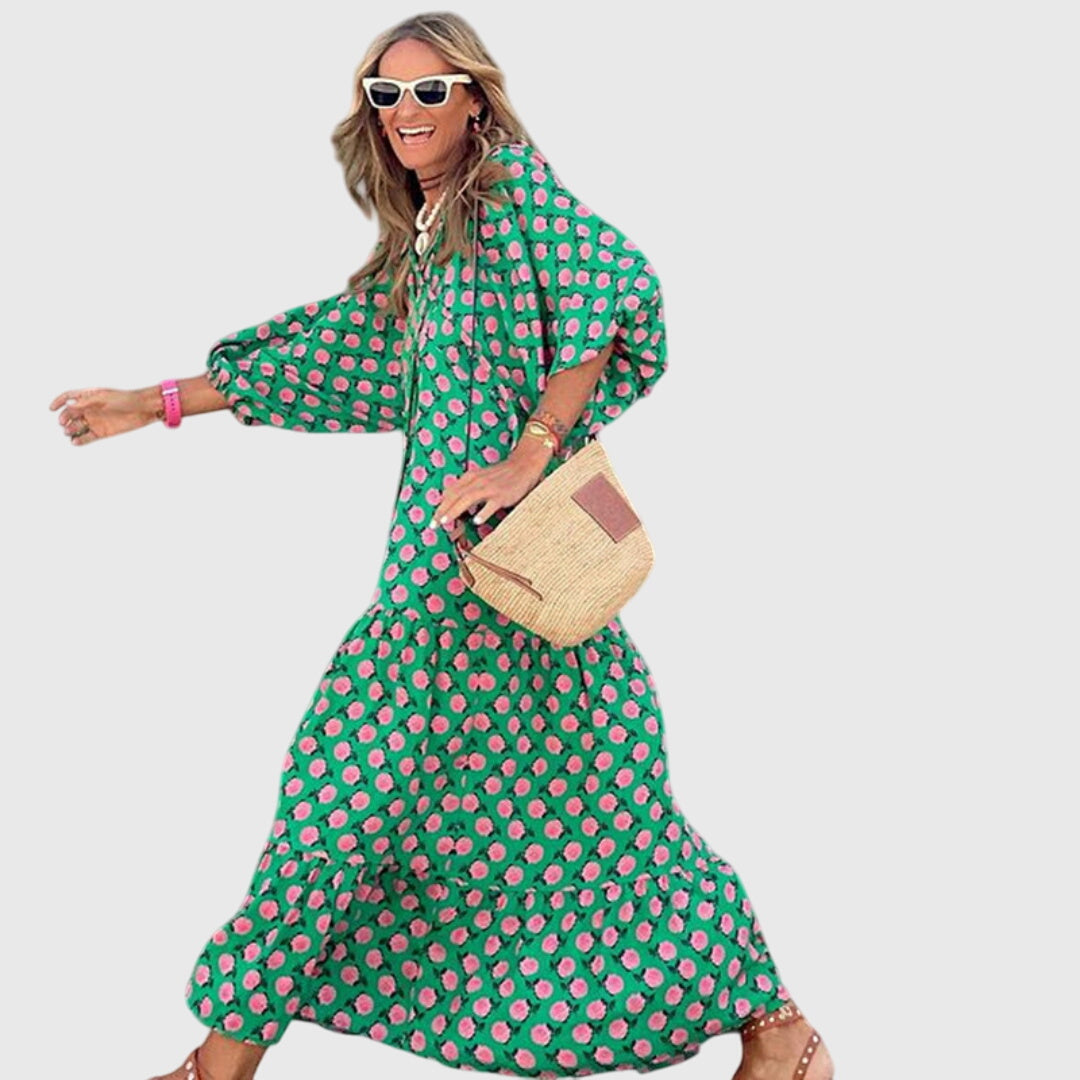 Woman wearing a vibrant green and pink polka dot Boho Maxi Dress with long sleeves and tiered skirt