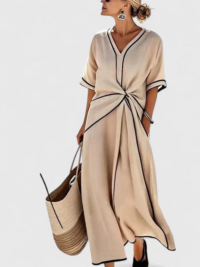 Woman wearing beige Summer Linen Dress with contrast piping and front tie waist detail