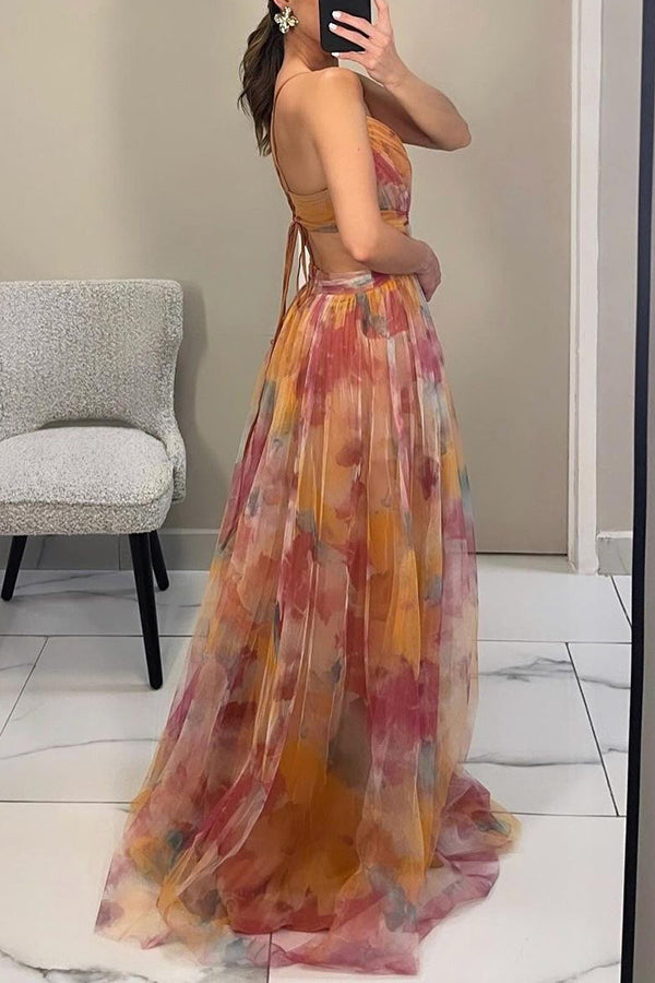 Woman twirling in floral print maxi dress highlighting the flowing fabric and maxi length