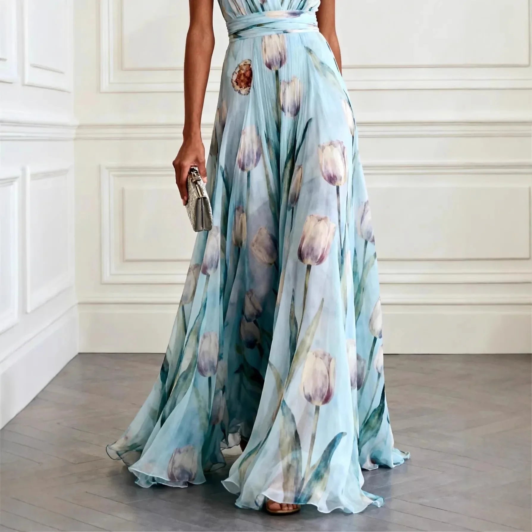 Front view of flowing maxi wedding guest dress featuring wrap waist and sleeveless design