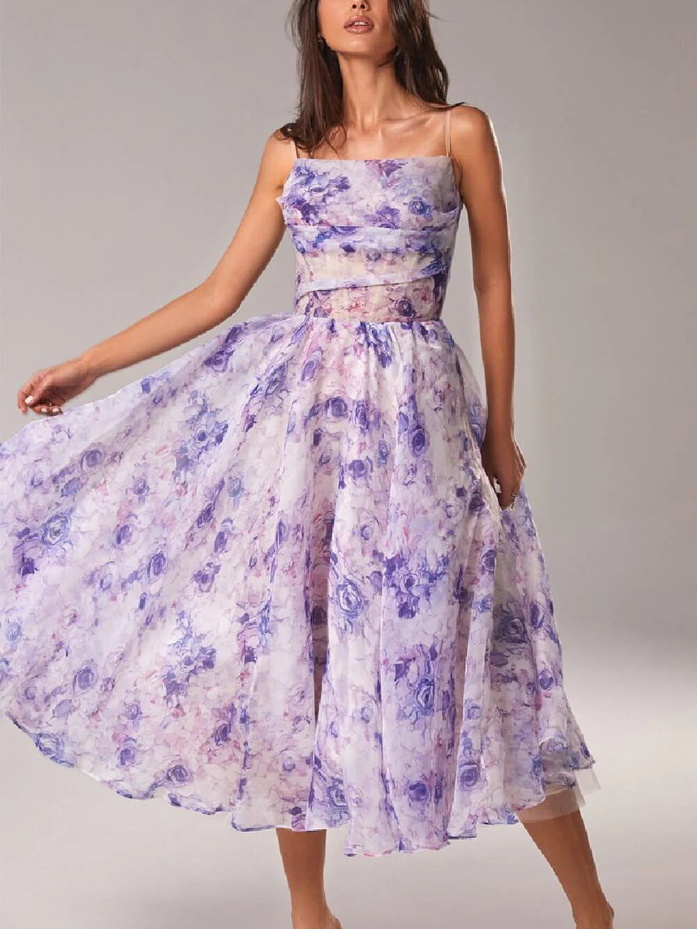 Floral print elegant midi dress showing full A-line skirt silhouette and fitted bodice with spaghetti straps