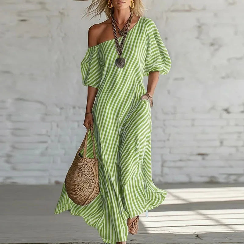 Side view of one shoulder puff sleeve dress showing asymmetric neckline and vertical stripe pattern detail