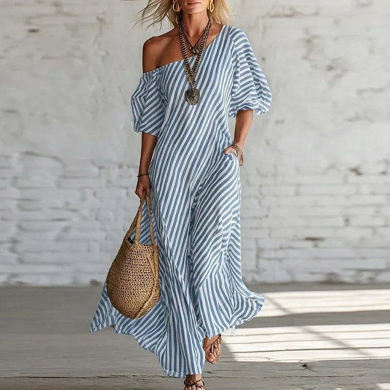 Close-up of puff sleeve detail on one shoulder dress with lightweight woven striped fabric