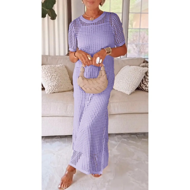 Woman wearing elegant maxi dress with sheer knit overlay in lavender purple, styled with woven handbag
