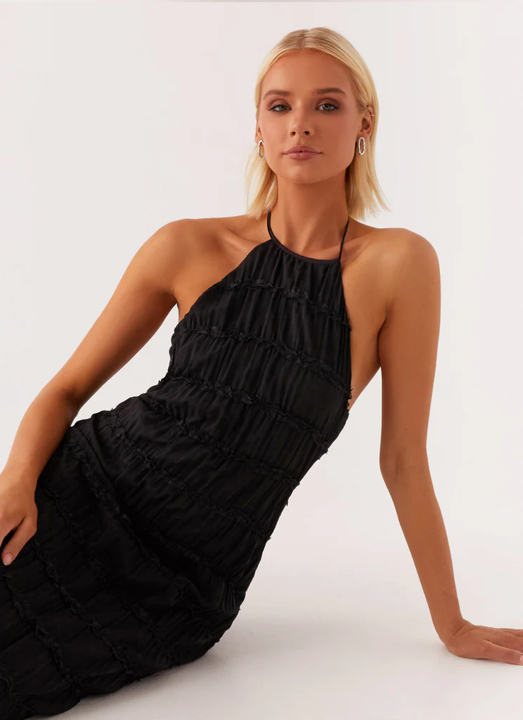 Halter maxi dress worn at formal event showing full-length elegant silhouette