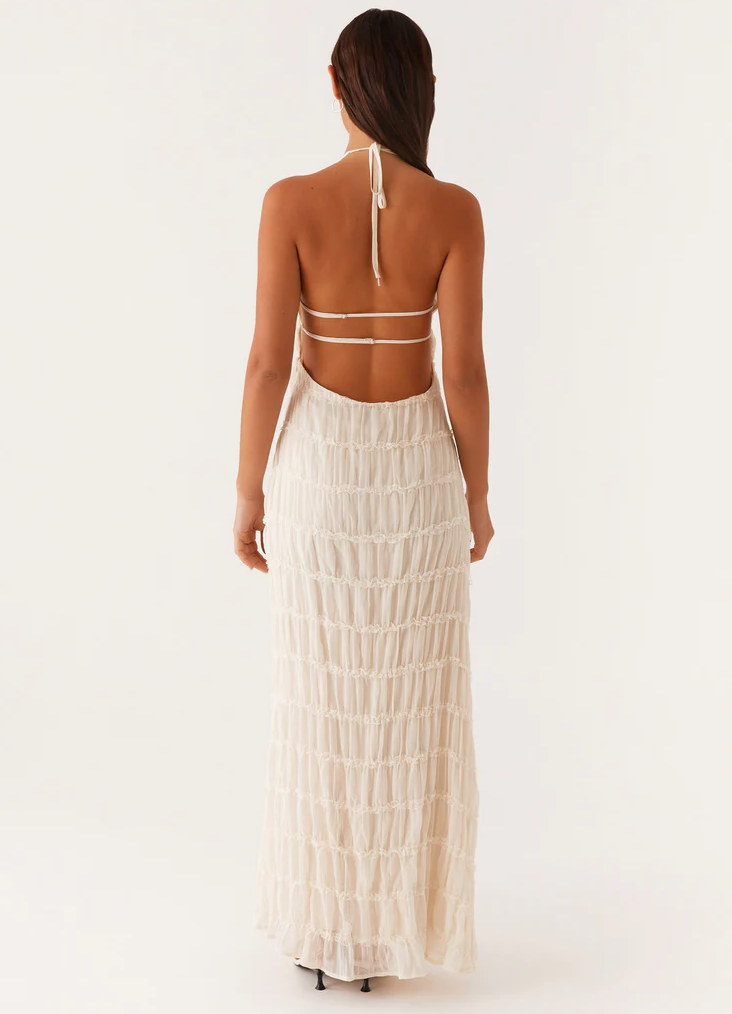 Halter maxi dress styled with minimal accessories for wedding guest look