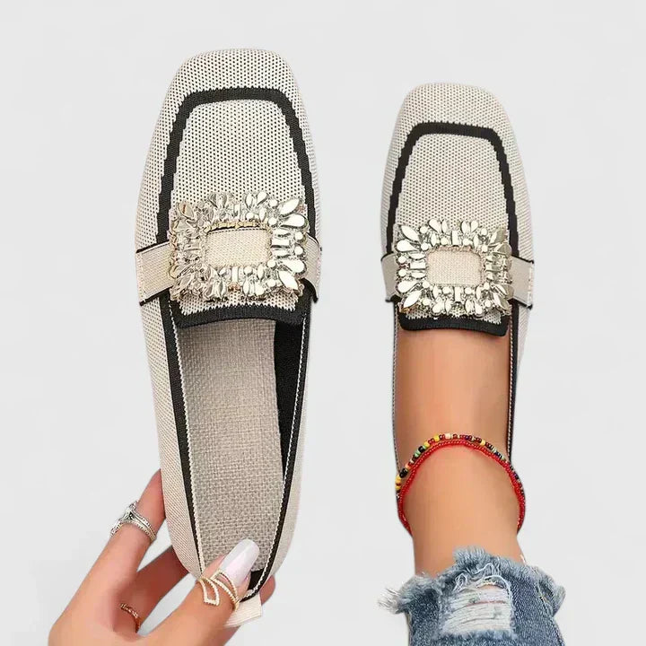 Women's orthopedic loafers showing slip-on design and structured upper with decorative hardware