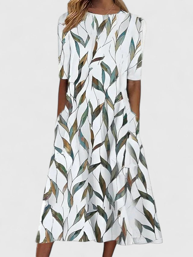 Close-up view of the all-over blue floral pattern on a relaxed midi dress with round neckline