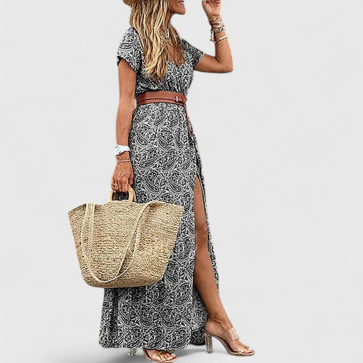 Back view of sophisticated maxi dress showing gathered waist and flowing skirt