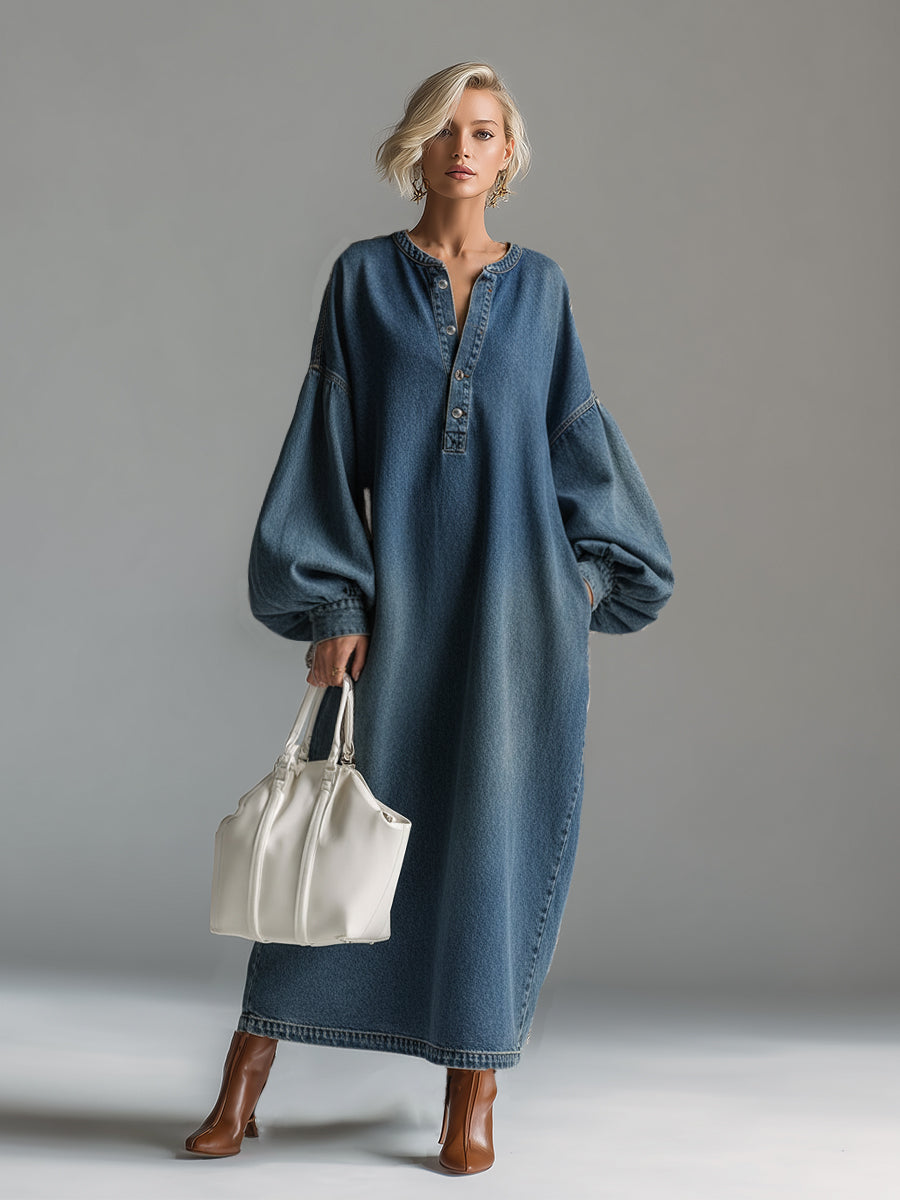 Side view of blue denim maxi dress showing relaxed fit and ankle-length hem with topstitched detailing