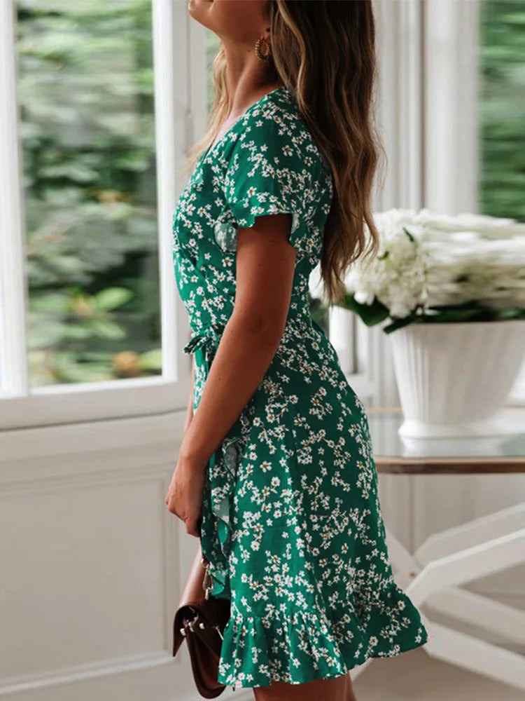 Close-up view of floral print pattern and wrap waist detail on mini dress